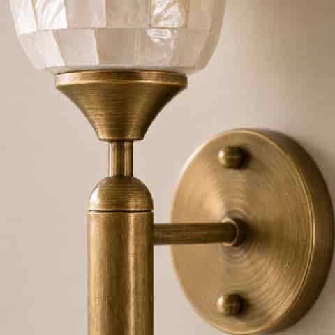 Detailed natural shell mosaic shade and antique brass wall sconce construction