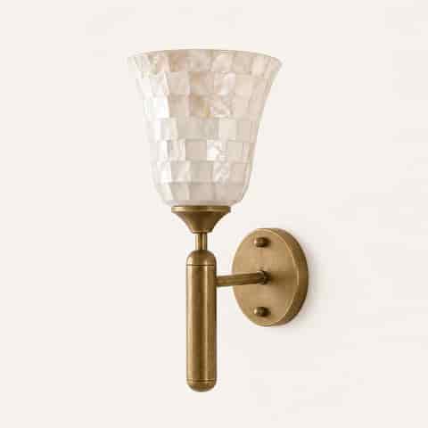 Close up of antique brass wall sconce hardware with pearlescent natural shell mosaic shade
