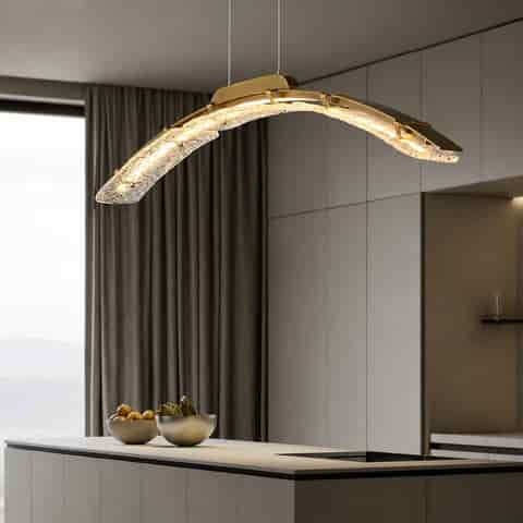 Sculptural copper linear pendant with curved water ripple textured glass and warm light above a minimalist kitchen island