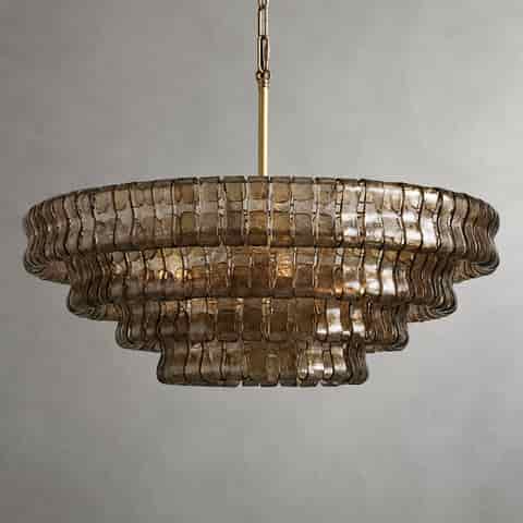 Detailed view of textured glass chandelier layers with warm illumination and reflective glass surfaces
