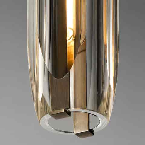 Close up of thick clear crystal pendant shade with polished copper interior structure