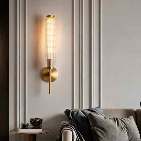 Slim gold fluted glass wall sconce with copper frame in a modern living room