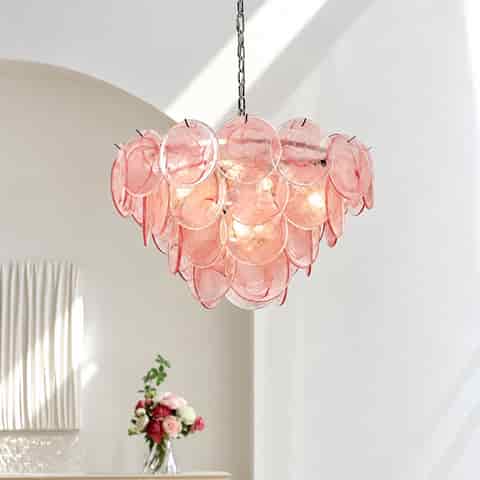 Pink Murano glass pendant chandelier displayed in a bright modern interior with natural daylight and floral decor