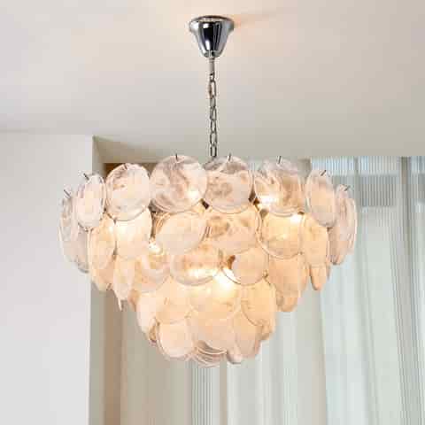 White Murano glass chandelier with layered translucent discs and soft warm illumination in a contemporary room
