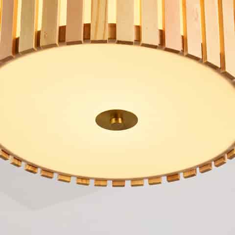 Close up of wood slat drum pendant light with frosted bottom diffuser and brass center detail