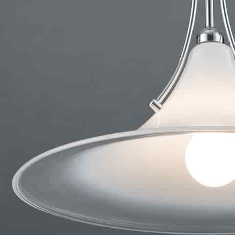 Close up of gradient frosted glass pendant shade with clear outer edge, polished metal supports and exposed warm light source