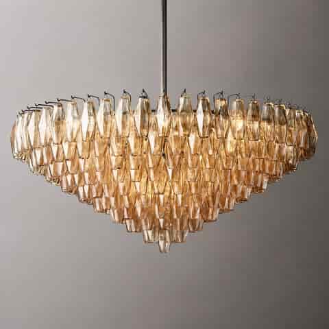 Tiered amber glass cascade chandelier with dark metal downrod and sculptural bowl shaped silhouette
