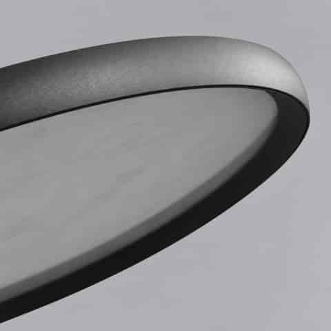 Close up of the luminous swirling pattern on a translucent modern ceiling light diffuser with black trim