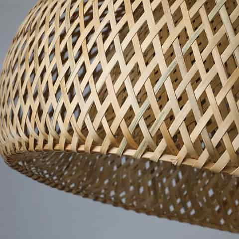 Close up of handwoven bamboo pendant light with double layer cross weave dome shade