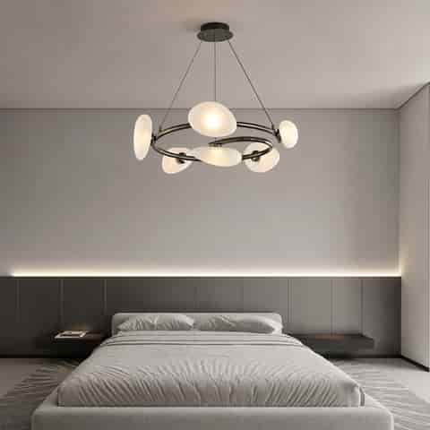 Modern ring chandelier with frosted textured glass shades above a contemporary bedroom