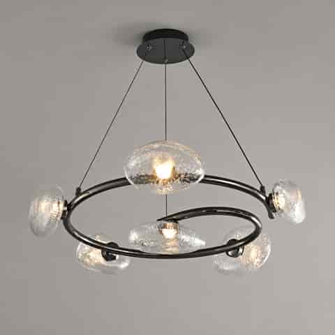 Modern black textured glass ring chandelier illuminated with warm light