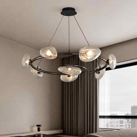 Sculptural black ring chandelier with clear water textured glass shades in a modern interior