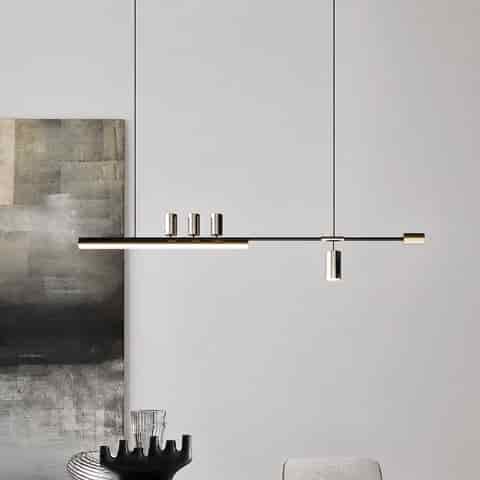 Modern black and gold linear LED pendant light with cylindrical spotlights in a minimalist contemporary interior
