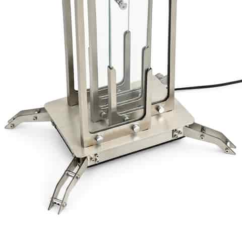 Detailed view of clear glass panels, brushed metal frame and precision connectors on a modern LED table lamp