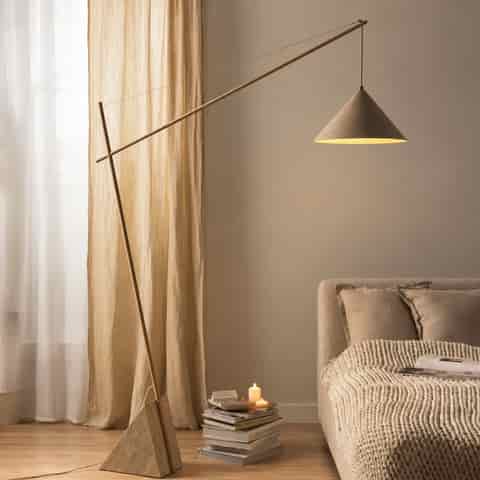 Contemporary ivory beige cantilever floor lamp with a geometric marble base, slim iron frame and directional tapered iron shade