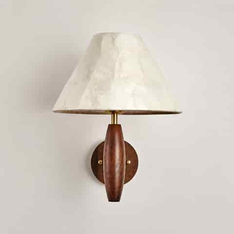 Front view of wood and Capiz shell bedroom wall sconce with brass accent