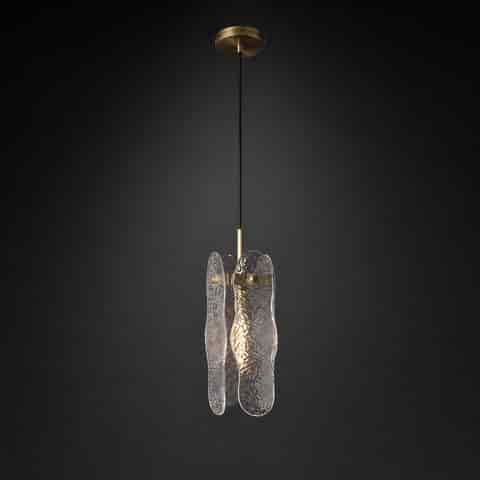 Small textured glass pendant light beside a bed with warm diffused illumination