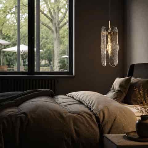 Textured glass bedside pendant light creating a warm accent in a modern bedroom