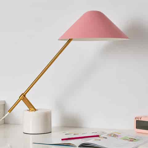 Blush pink cantilever table lamp with an ivory stone base and polished gold angled metal arm